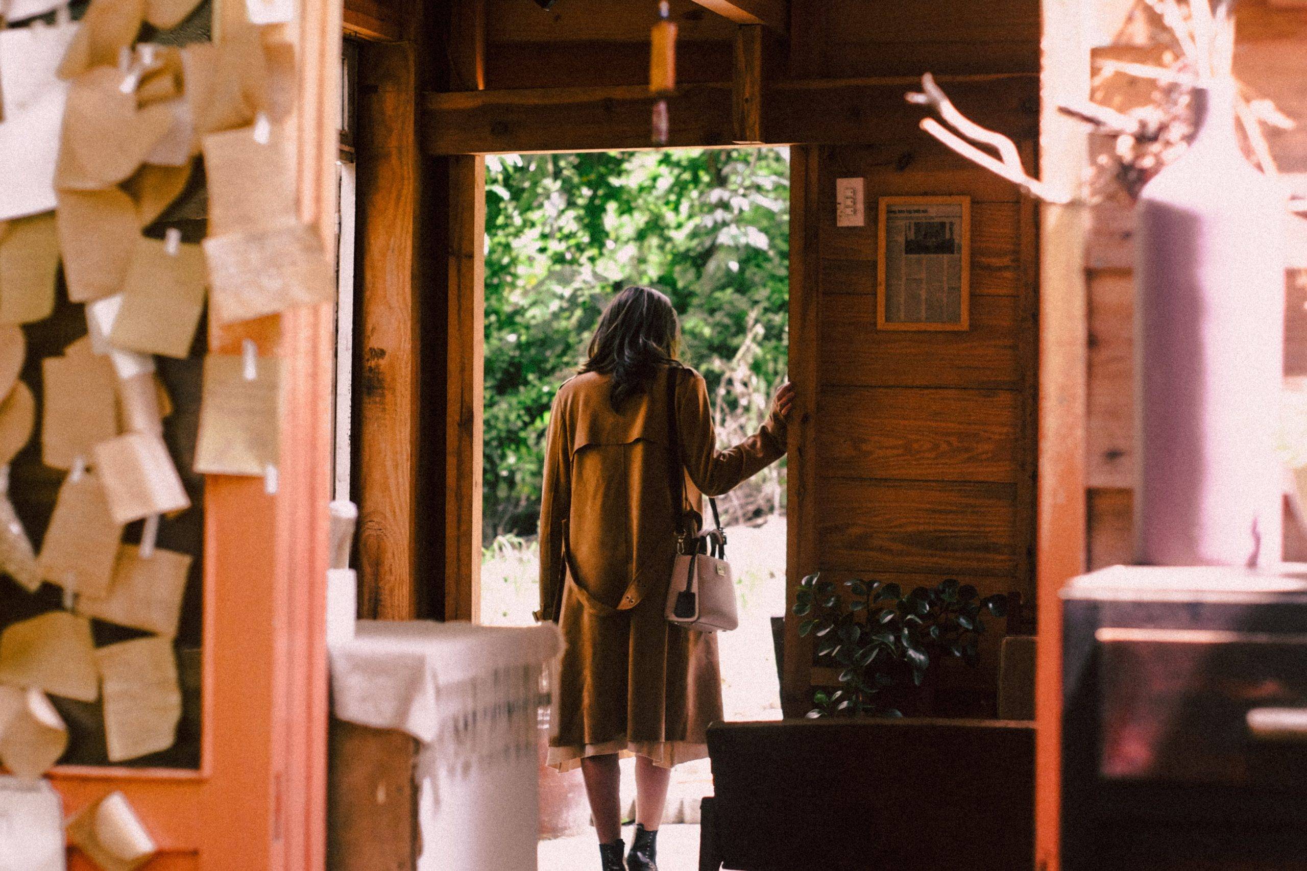 woman-standing-near-open-door-about-to-step-outside-2297663