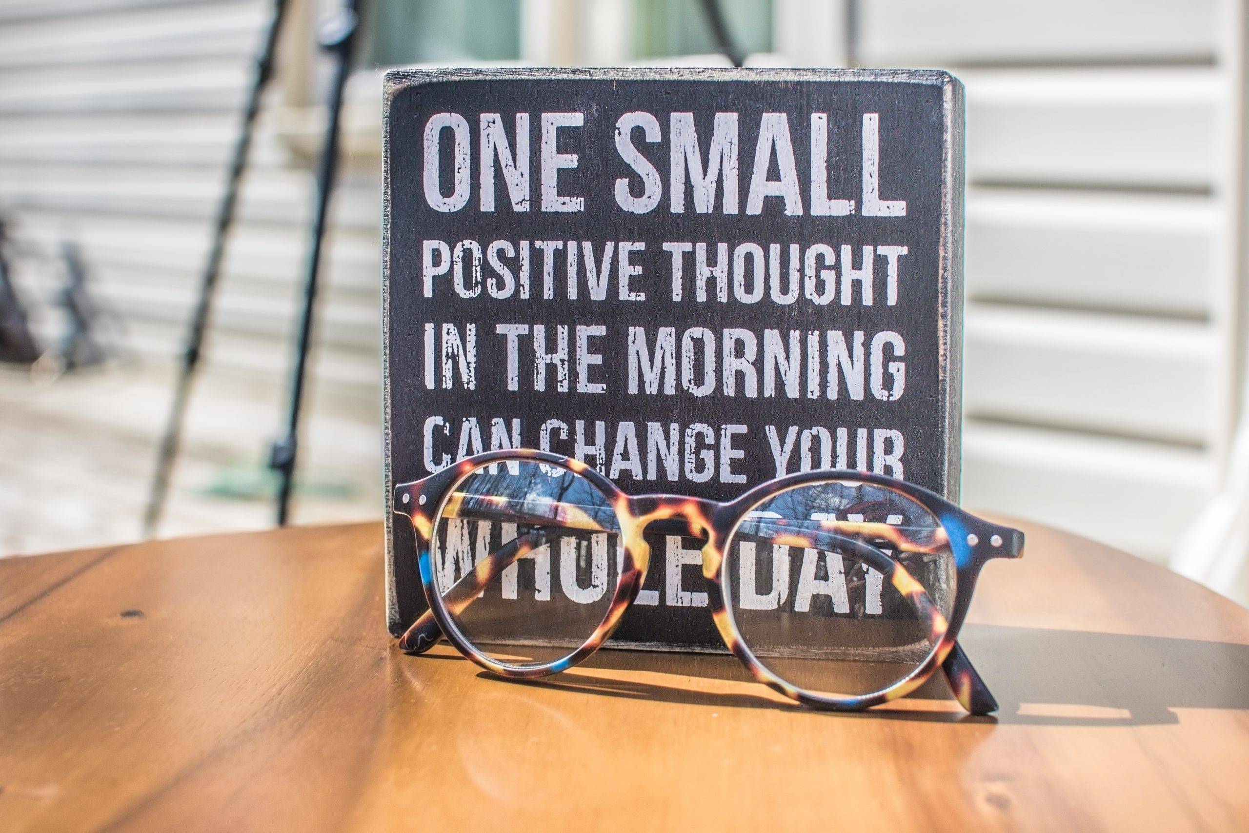 photo-of-a-sign-and-eyeglasses-on-table-1485657